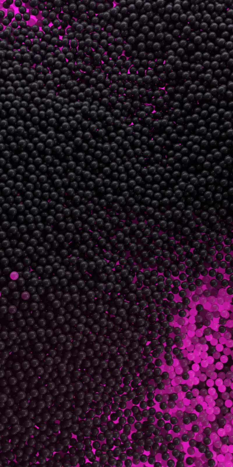 Movement of a pile of black and lilac balls.