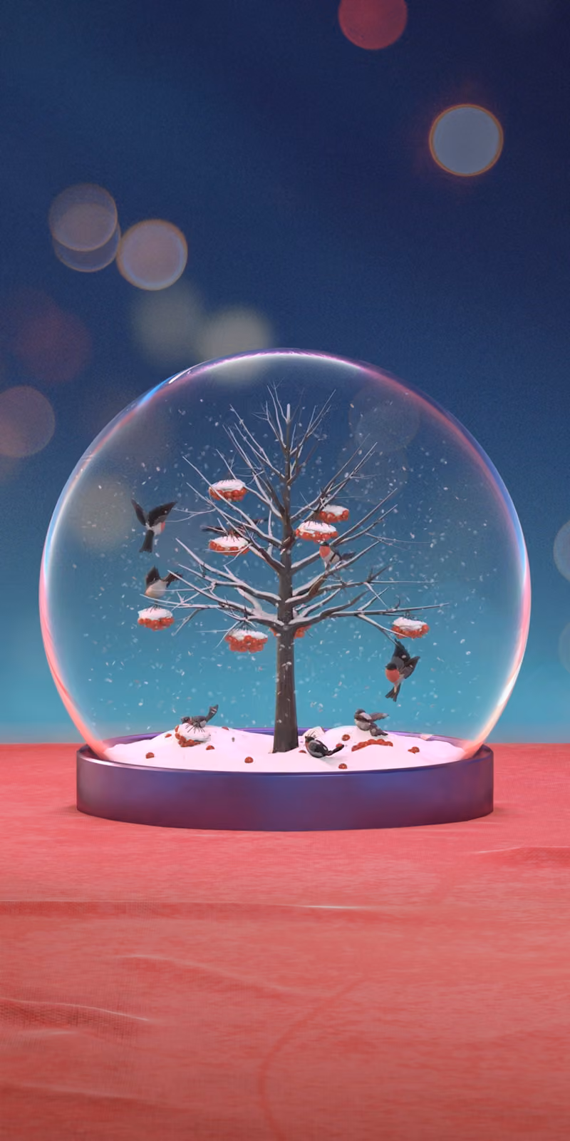 Bullfinches perch beside rowan berries inside a Christmas snow globe.