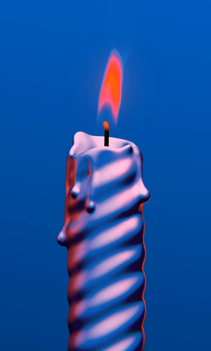 A striped candle burns against a deep blue background.