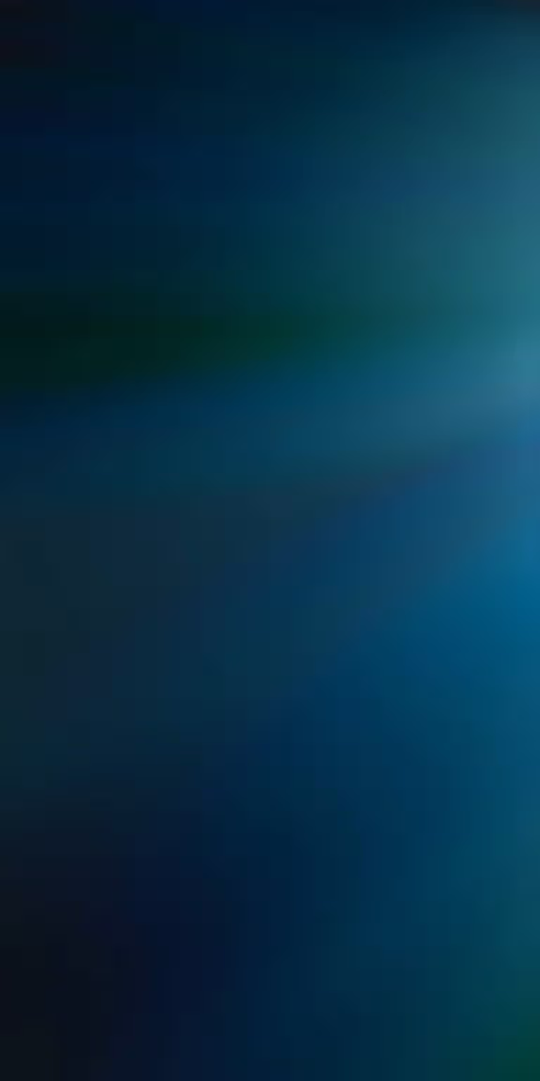Blue-green light caustics shimmer across a dark surface.