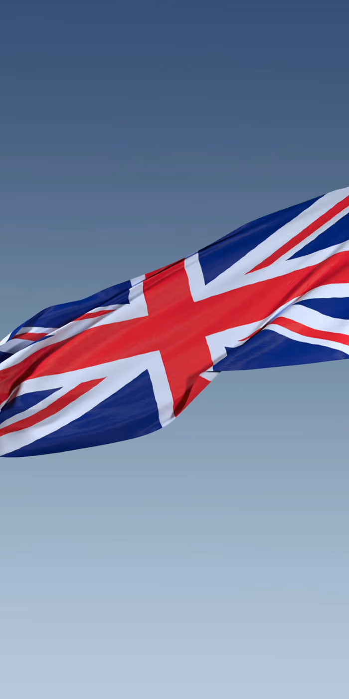 The British flag waving against the sky.