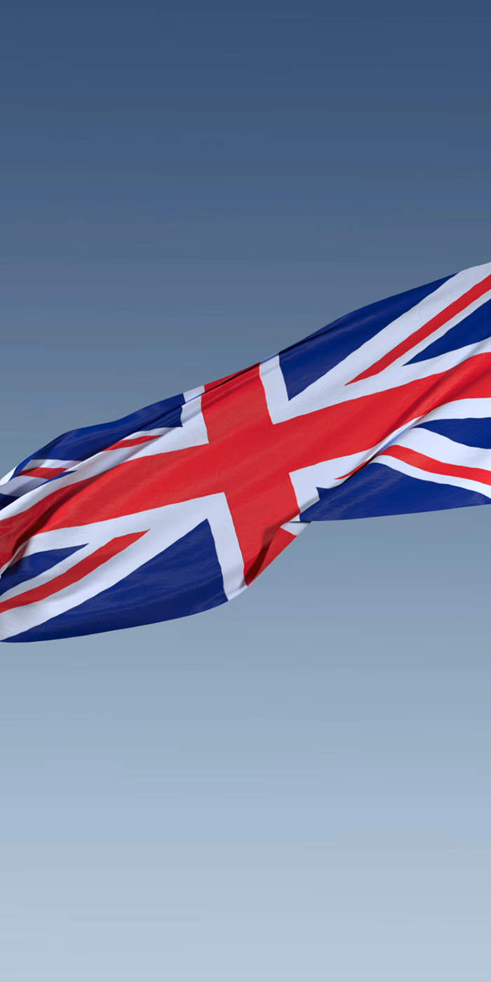 The British flag waving against the sky.