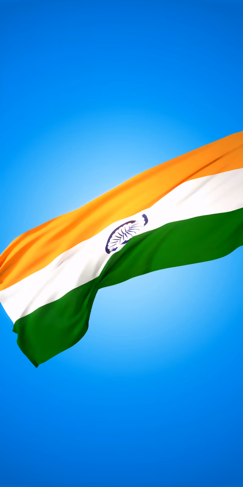 The flag of India waving against the blue sky.