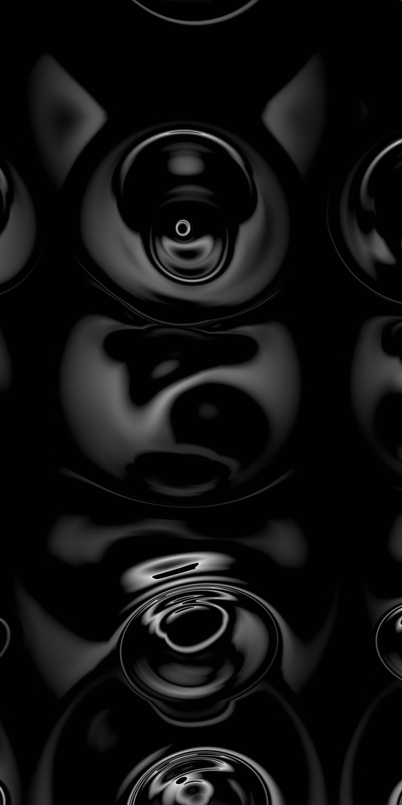 Large black-and-silver circles pulse in a dark seamless loop.