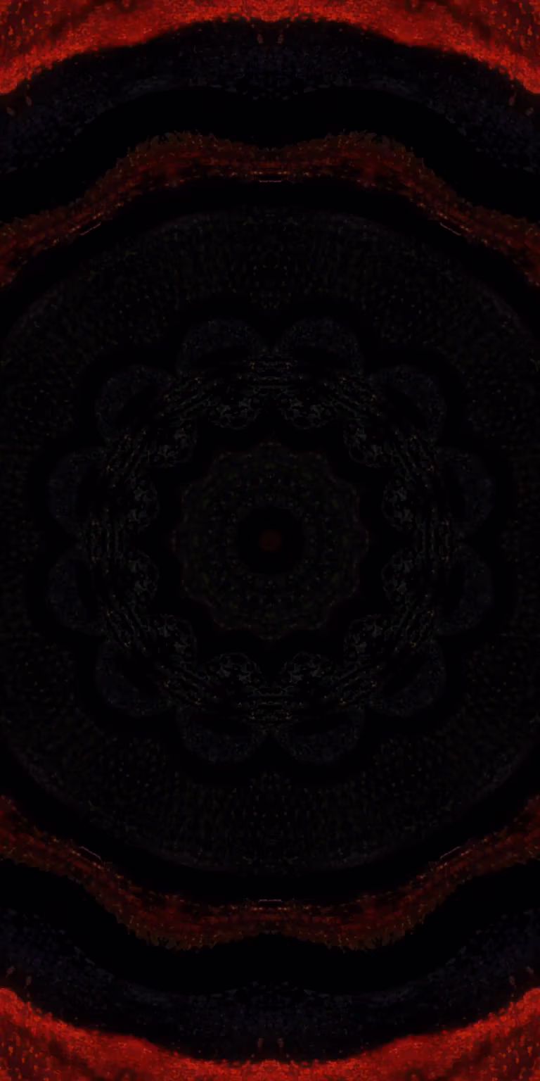 Red and black colors glitter in the kaleidoscope.