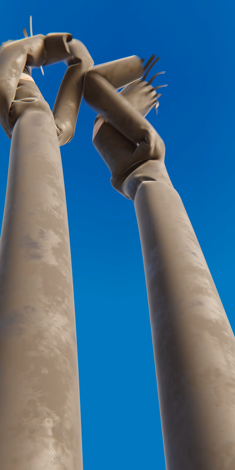 Two inflatable black skydancers sway against a bright blue sky.