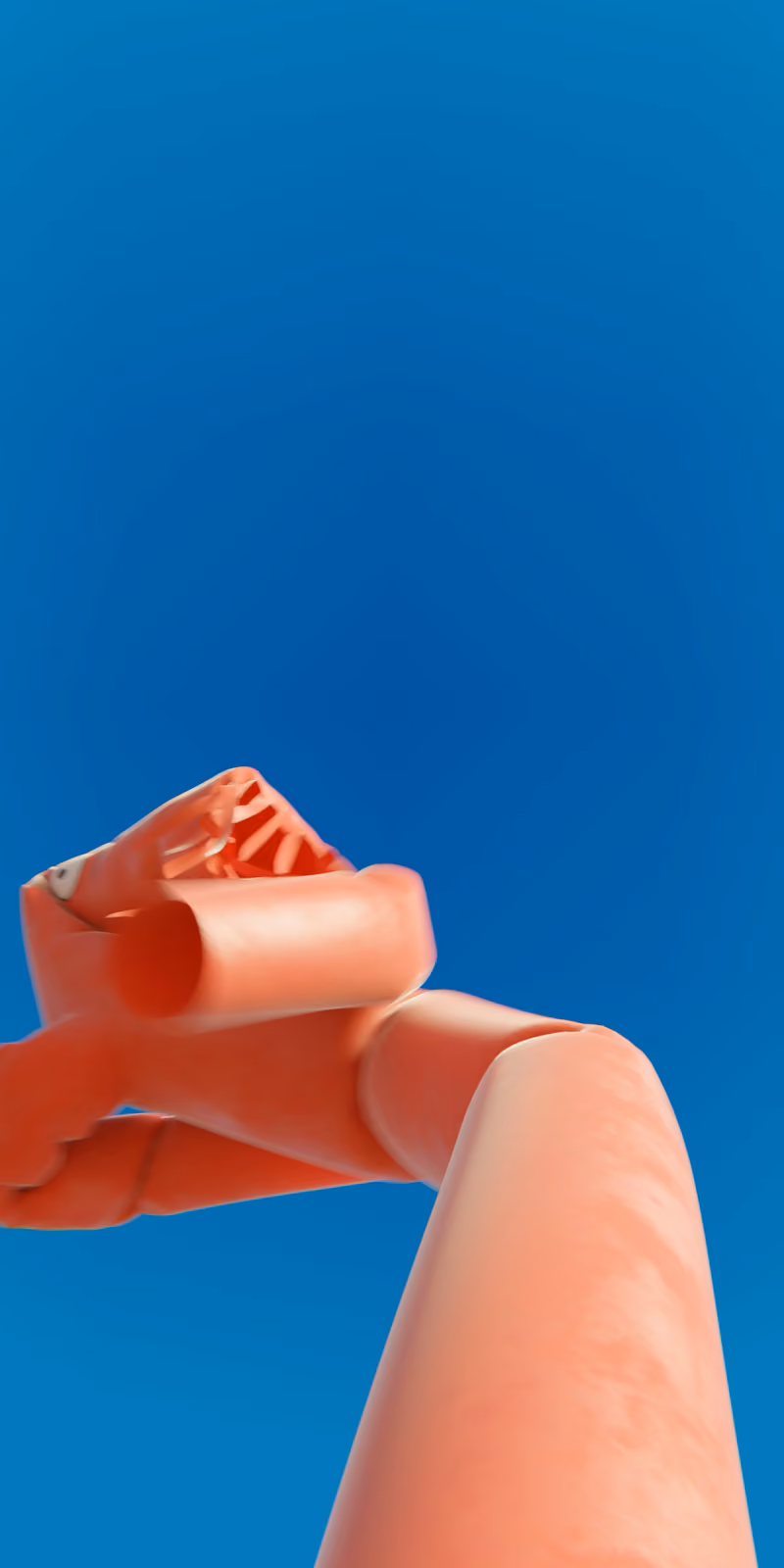 An inflatable red skydancer sways against a bright blue sky.
