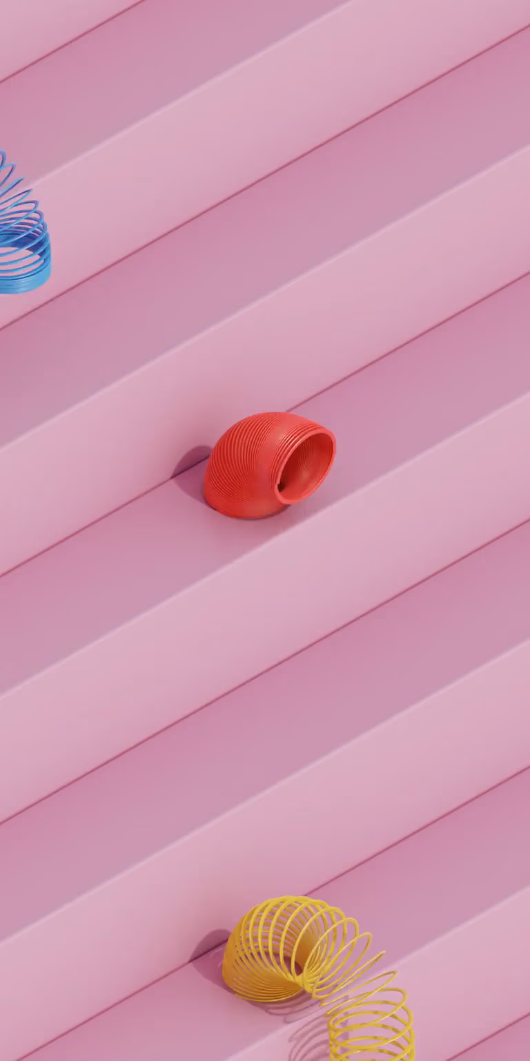 Colorful slinkies walk down the stairs.
